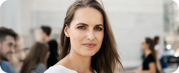 A confident woman looking at the camera outdoors