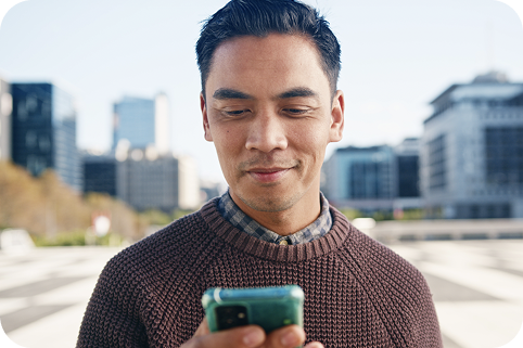 A man using a phone in the city