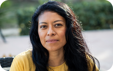 Portrait of a woman with dark hair looking at the camera