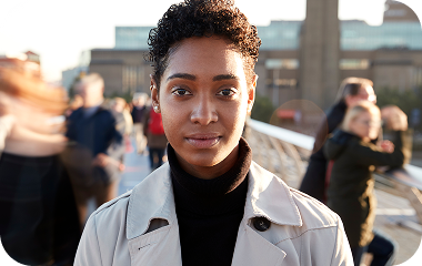 A woman looking into the camera in the city