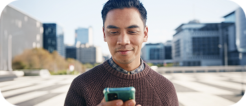 A man using a phone in the city